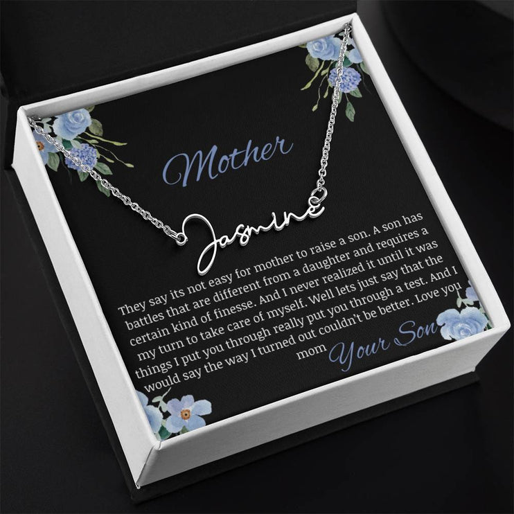 A polished stainless-steel signature name necklace in a two-tone box.