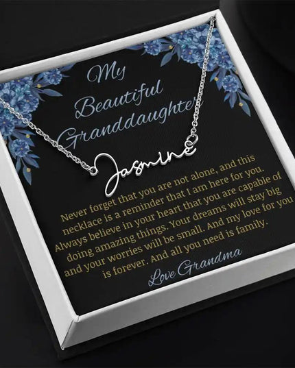 Signature Name Necklace with a polished stainless-steel finish on a to my beautiful granddaughter from grandma greeting card angle to the left in a two-tone box