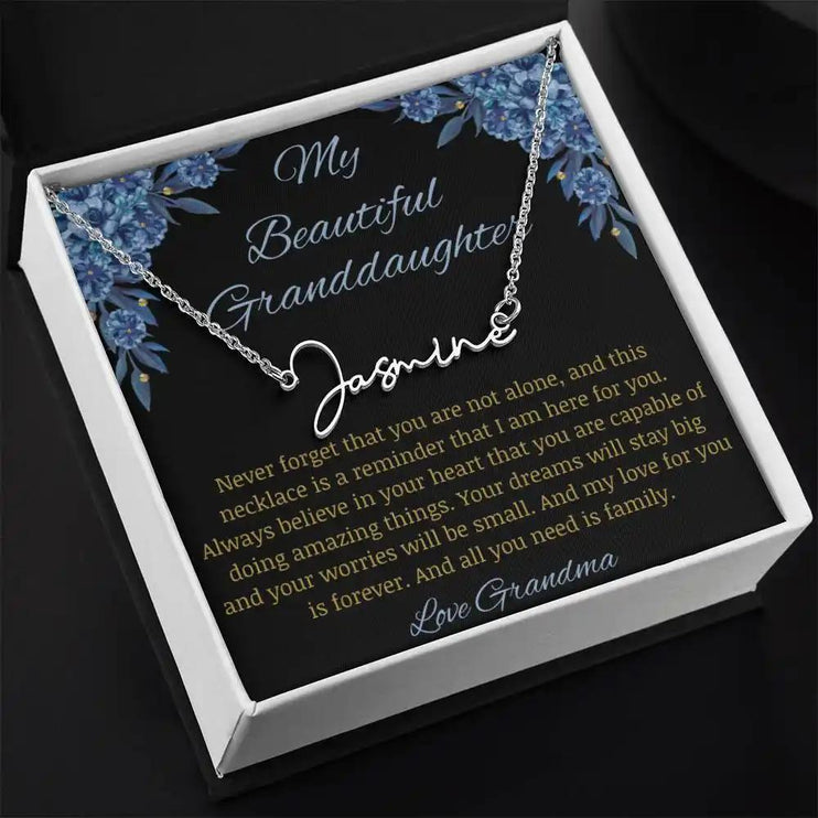 Signature Name Necklace with a polished stainless-steel finish on a to my beautiful granddaughter from grandma greeting card angle to the left in a two-tone box