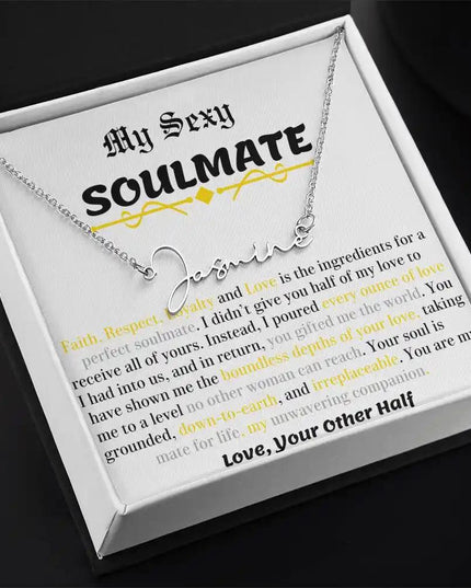 a polished stainless-steel signature name necklace in a two-tone box angled left.