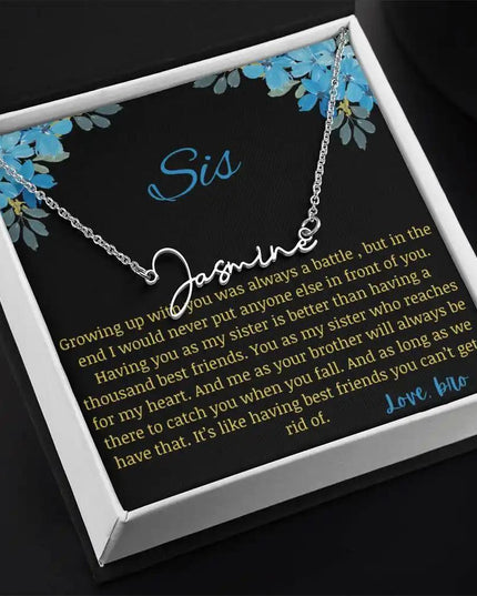 Signature Name Necklace with a polished stainless-steel charm on a to sis from bro greeting card in a two-tone box angled slightly to the right