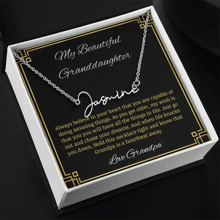 Signature Name Necklace with a polished stainless-steel finish on a to granddaughter from grandpa greeting card in a two-tone box