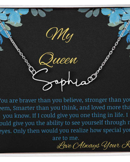 A polished stainless-steel signature name necklace in a two-tone box with a to my queen greeting card.