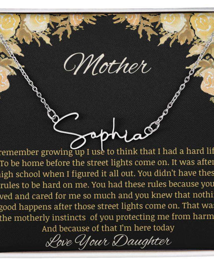 A polished stainless-steel signature name necklace.