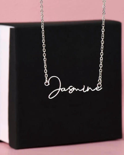 polished steel signature style name necklace on top soft box