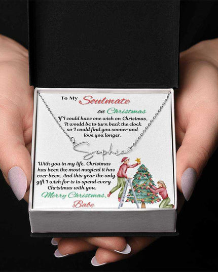 stainless-steel signature name necklace in a soft box in model's hands