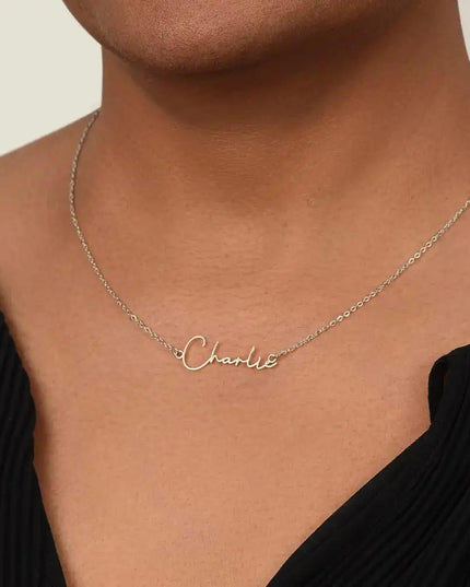 polished-stainless signature style name necklace on model's neck