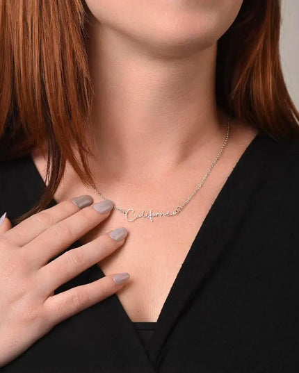 polished steel signature style name necklace on model's neck