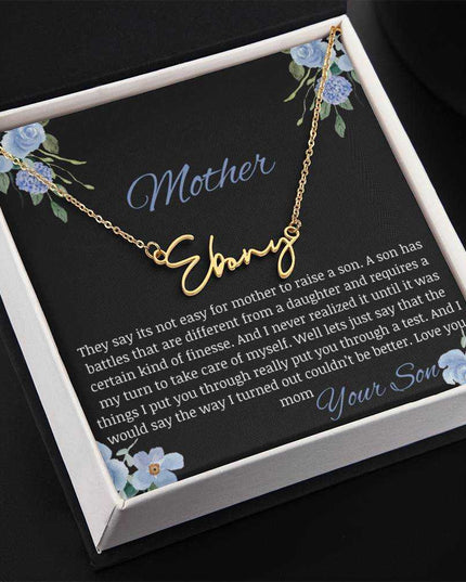 A yellow gold finish signature name necklace in a two-tone box.