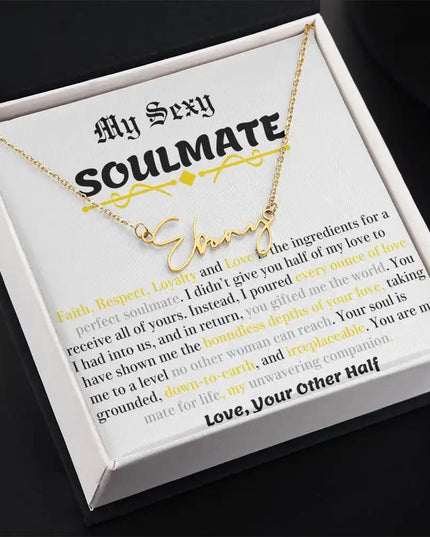 a yellow gold signature name necklace in a two-tone box angled left.