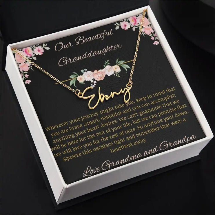 Signature Name Necklace with a yellow gold finish and a to granddaughter from grandma and grandpa greeting card in a two-tone box 
