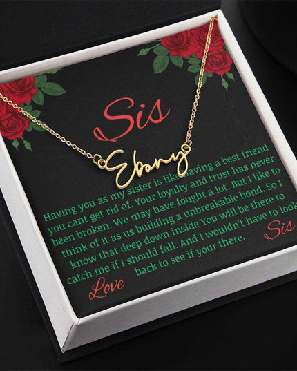 Signature Style Name Necklace with a yellow gold finish variant on a To Sis from Sis greeting inside a two-tone box angled slightly to the left.