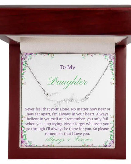 a polished stainless steel signature name necklace up close in mahogany box