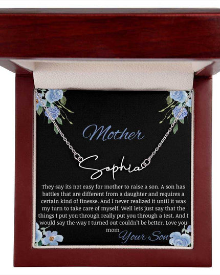 A polished stainless-steel signature name necklace in a mahogany box.