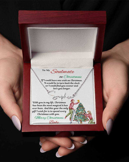 stainless-steel signature name necklace in a luxury box in model's hands