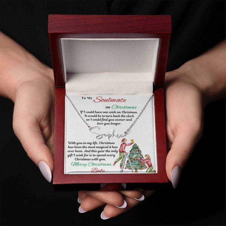 stainless-steel signature name necklace in a luxury box in model's hands
