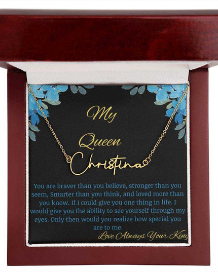 A polished yellow gold signature name necklace in a mahogany box with a to my queen greeting card.