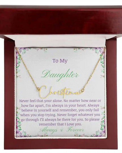 a yellow gold signature name necklace up close in mahogany box