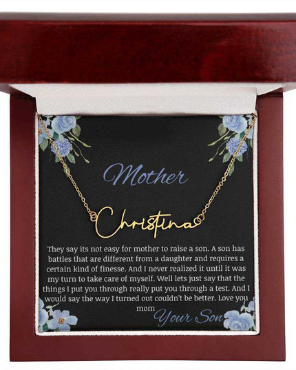 A yellow gold finish signature name necklace in a mahogany box.