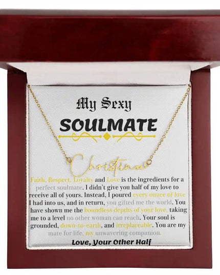 a yellow gold signature name necklace in a mahogany box.