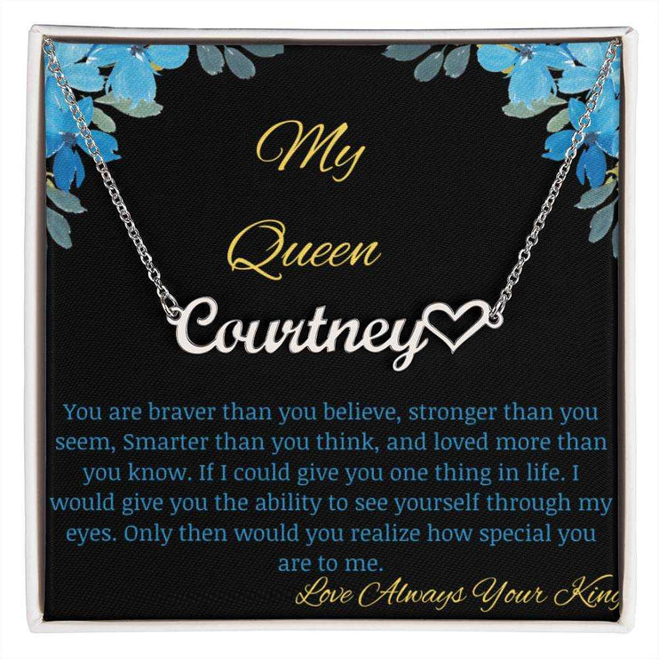 A polished stainless-steel name heart necklace on a to my queen greeting card.