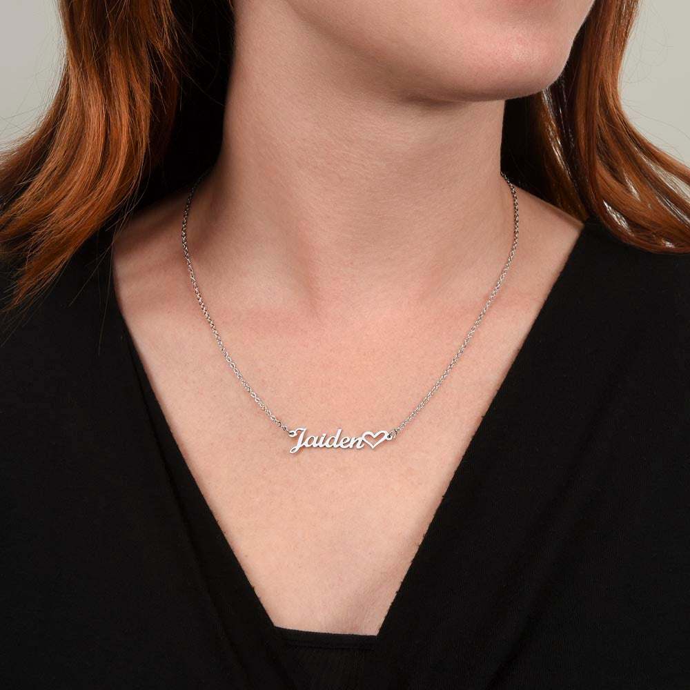 polished stainless-steel name heart necklace on a model's neck