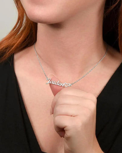 polished steel name heart necklace on model's neck