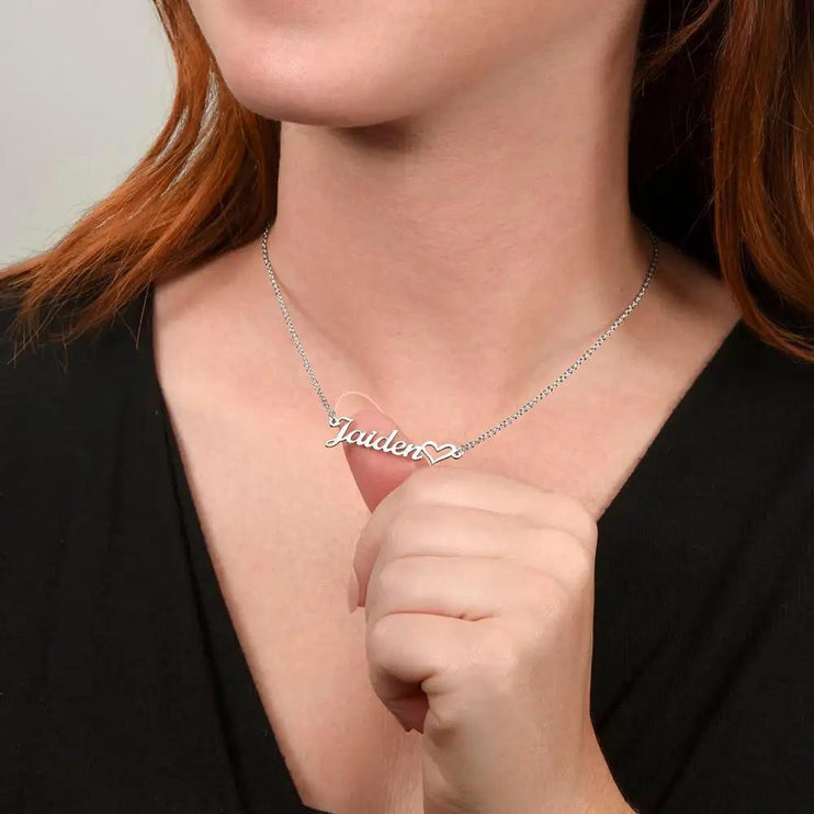 polished steel name heart necklace on model's neck
