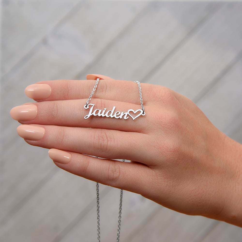 polished stainless-steel name heart necklace on a model's hand