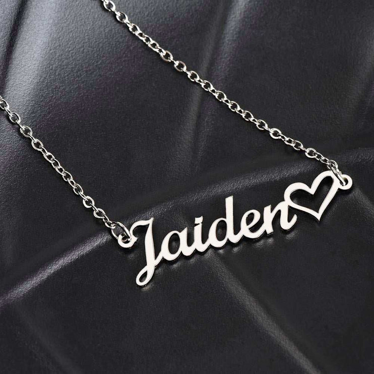 stainless steel name heart necklace on a black cushion