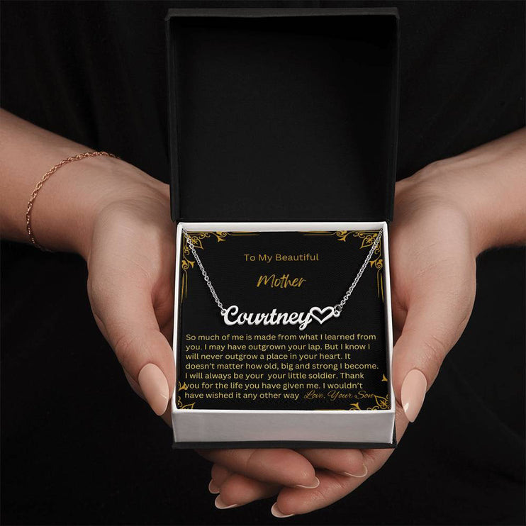 A polished stainless-steel name heart necklace in a two-tone box.