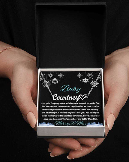 stainless-steel name heart necklace in soft box in model's hands