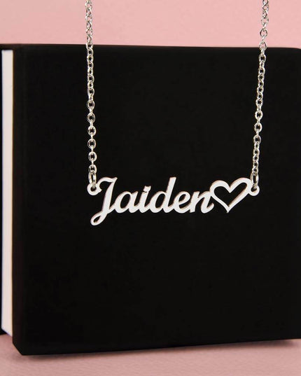 polished stainless-steel name heart necklace on top of a soft box