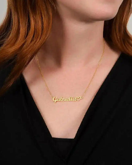 gold name heart necklace on model's neck