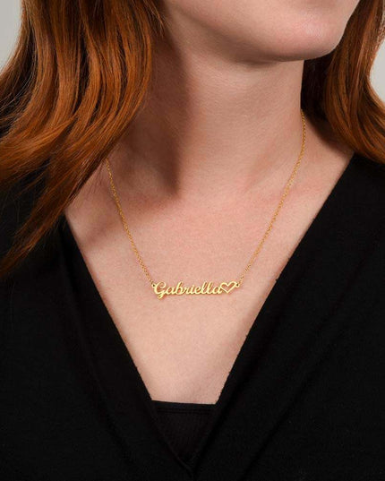gold name heart necklace on a model's neck