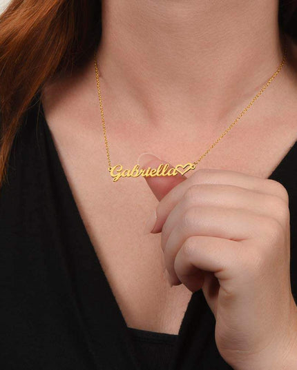 gold name heart necklace on a model's neck