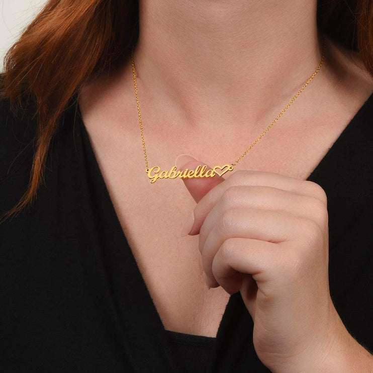 gold name heart necklace on a model's neck