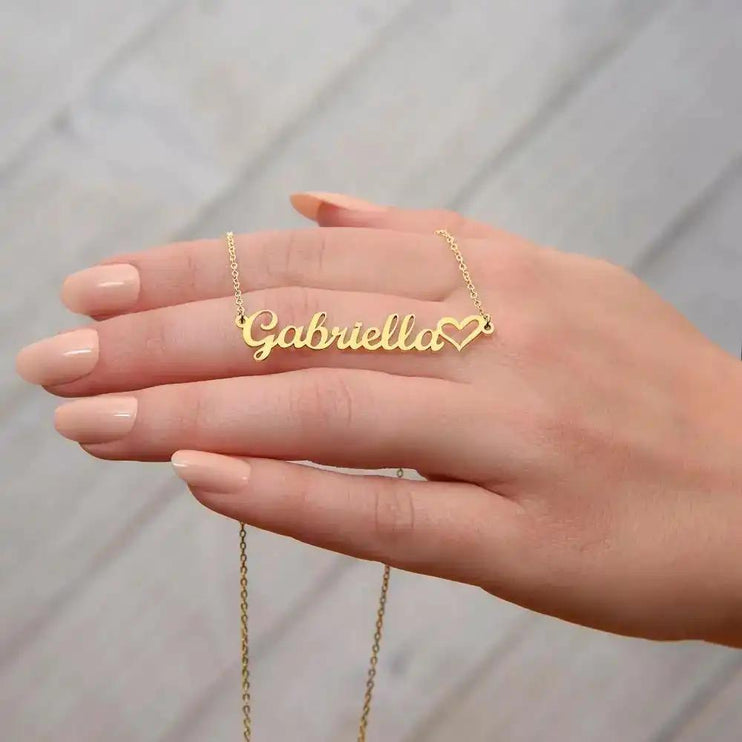 gold name heart necklace on model's hand