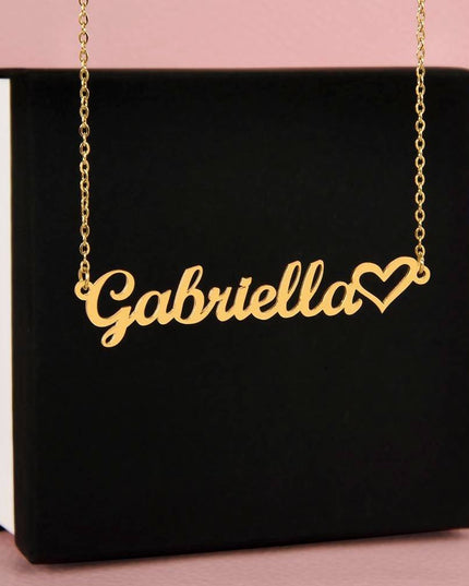 18k name heart necklace on top of soft box