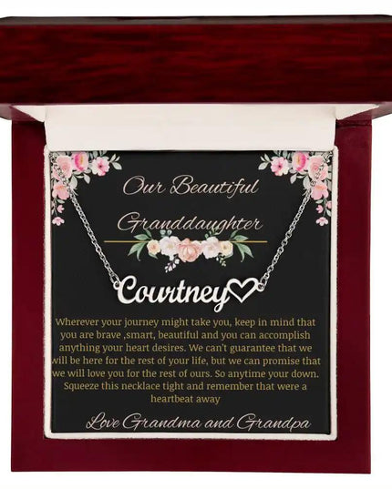 Name Heart Necklace with a polished stainless-steel finish on a to granddaughter from grandma and grandpa greeting card in a mahogany box