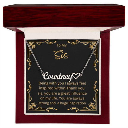 Name Heart Necklace with a polished stainless-steel variant on a To Sis greeting card inside a mahogany box up close view 