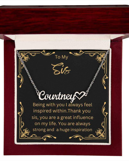 Name Heart Necklace with a polished stainless-steel variant on a To Sis greeting card inside a mahogany box up close view 