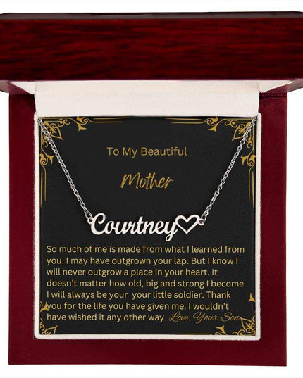 A polished stainless-steel name heart necklace in a mahogany box.
