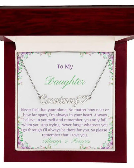A polished stainless-steel name heart necklace in a mahogany box