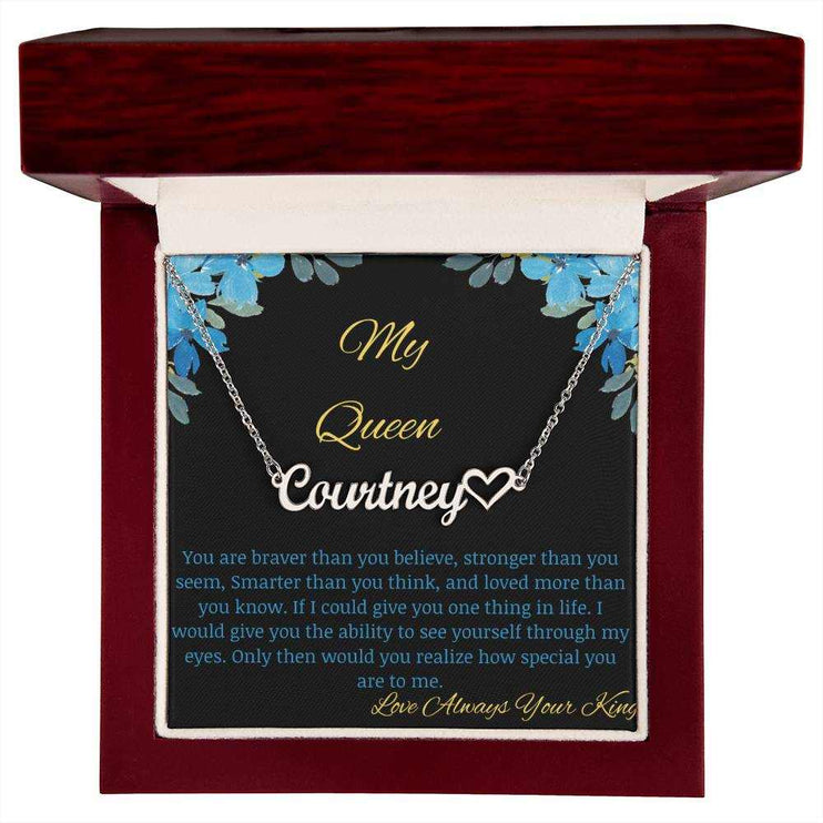 A polished stainless steel name heart necklace in a mahogany box with a to my queen greeting card.