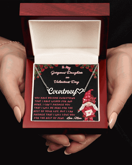 polished stainless-steel name heart necklace in a luxury box in model's hands