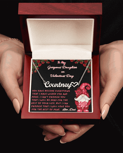 polished stainless-steel name heart necklace in a luxury box in a model's hands