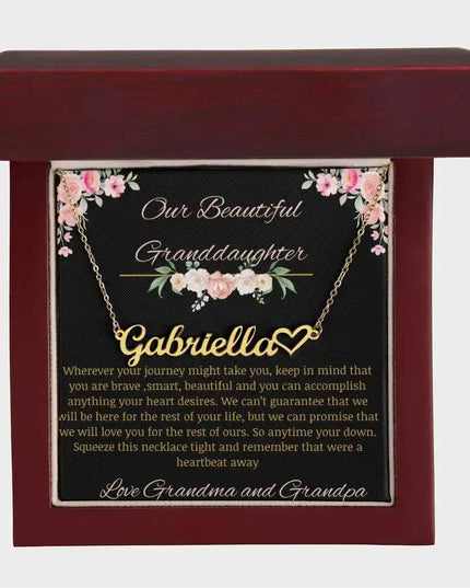 Name Heart Necklace with a yellow gold finish on a to granddaughter from grandma and grandpa greeting card in a mahogany box