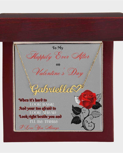 gold name heart necklace in a mahogany box birds eye view