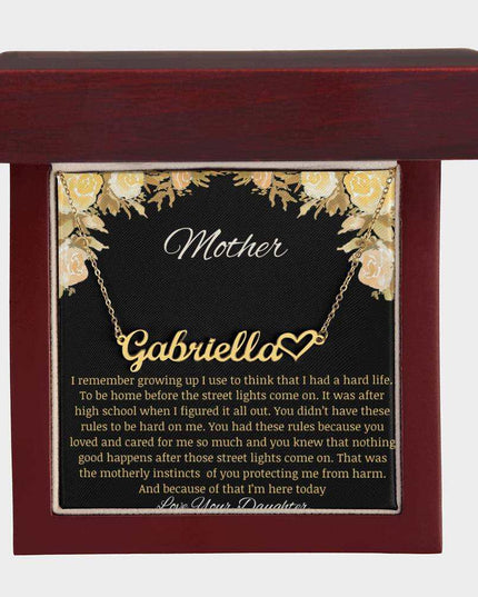 A yellow gold finish name heart necklace in a mahogany box.